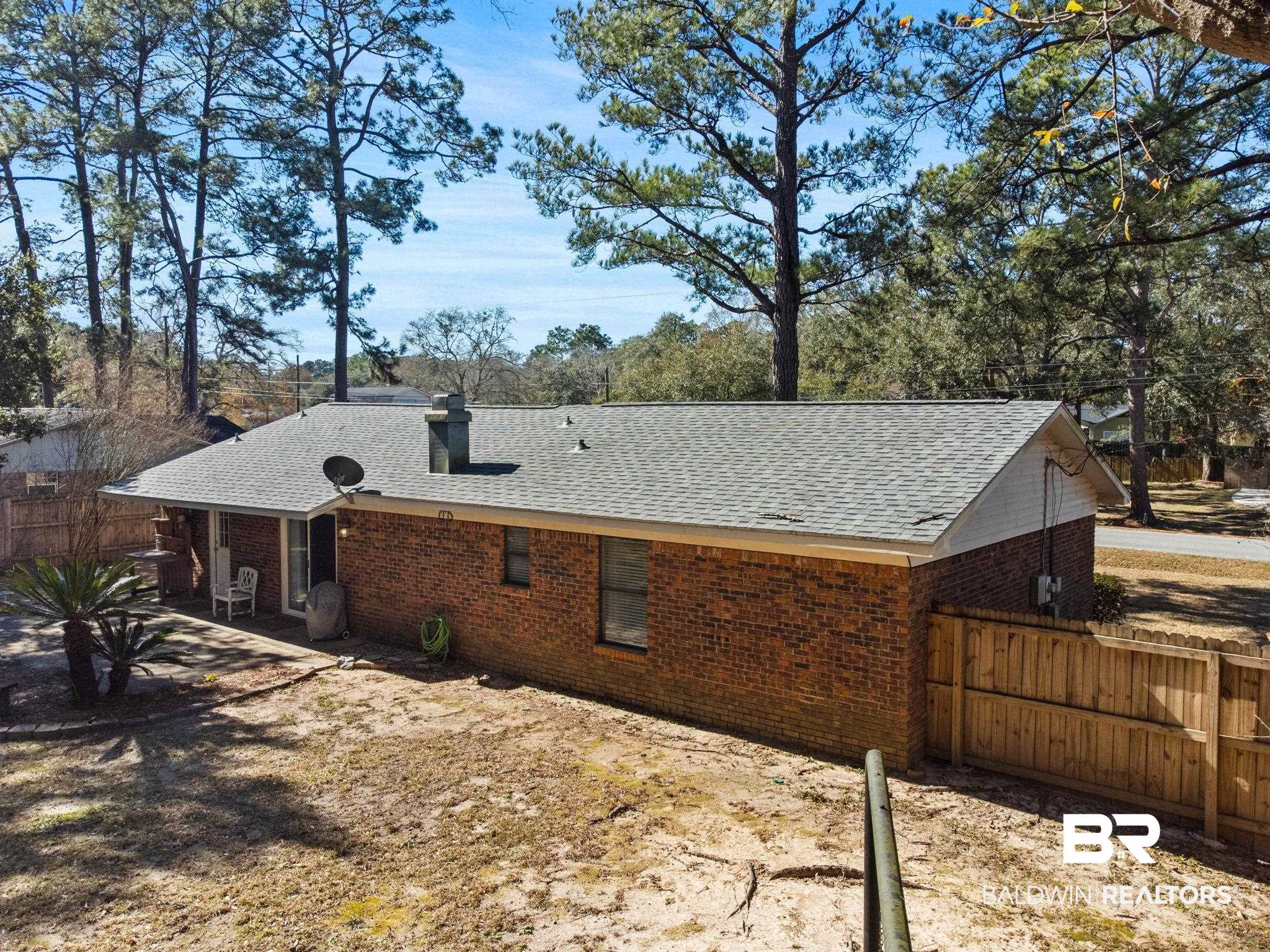 5366 Scanlan Way West Satsuma, AL 36572 - Photo 34 of 43 Rear view of house featuring a shingled roof, brick siding, a patio area, and a chimney