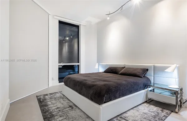 a bedroom with a bed and dresser