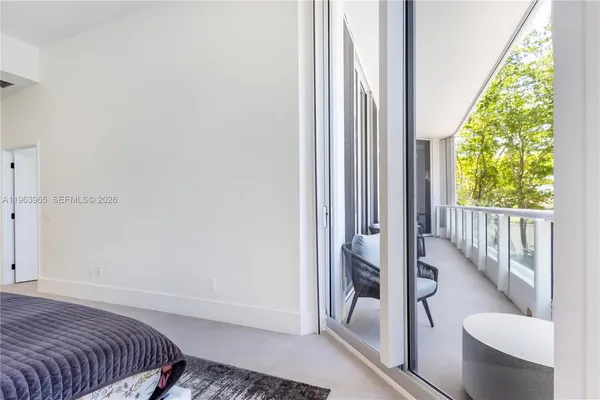 a view of bedroom with a bed and glass window