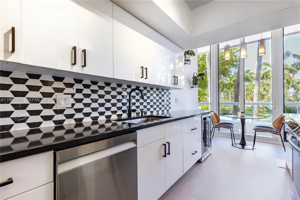 a spacious bathroom with a granite countertop sink and a large mirror