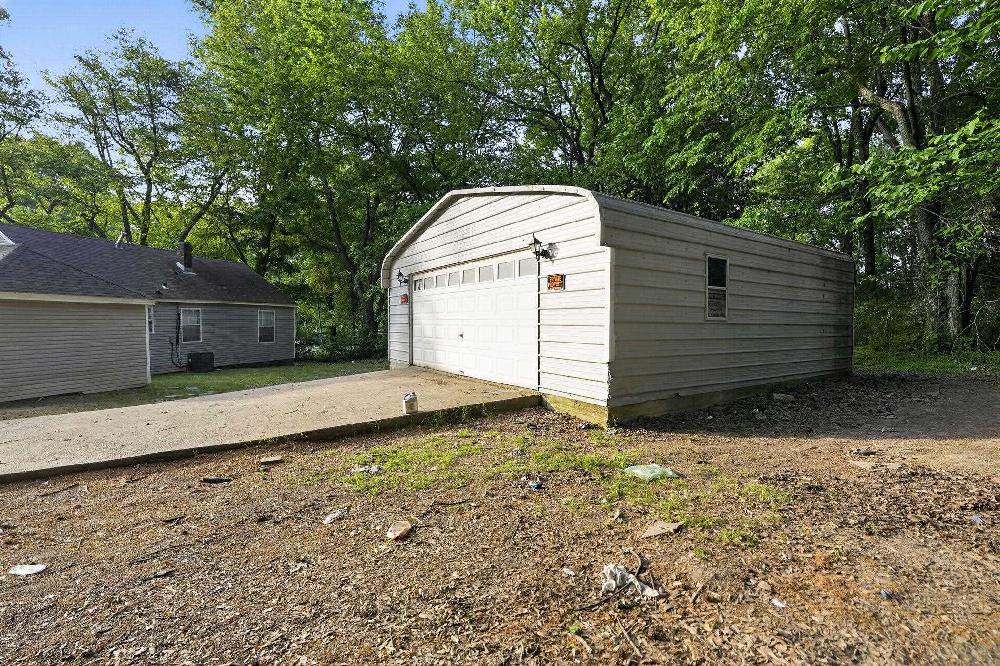 4199 Auburn Road Memphis, TN 38116 - Photo 4 of 32 Detached garage with metal siding, a single overhead door, and a side window