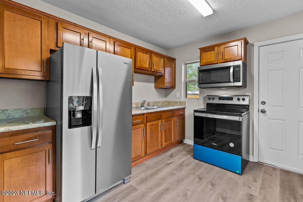 1023 Seba Street Jacksonville, FL 32205 - Photo 13 of 27 a kitchen with stainless steel appliances granite countertop a refrigerator stove and microwave