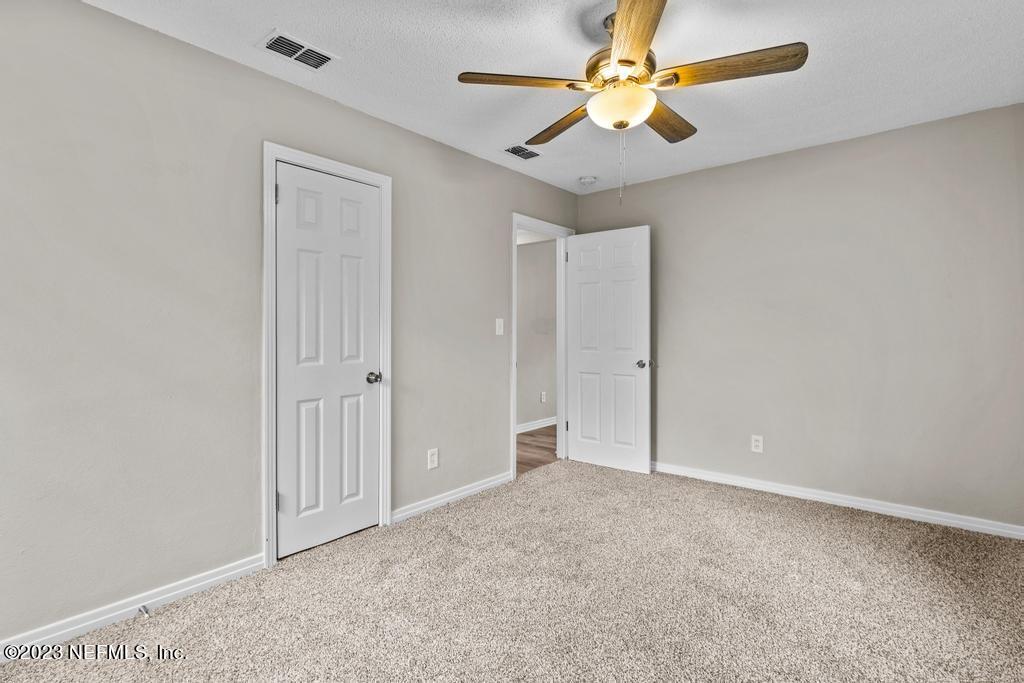 1023 Seba Street Jacksonville, FL 32205 - Photo 17 of 27 an empty room with windows and fan