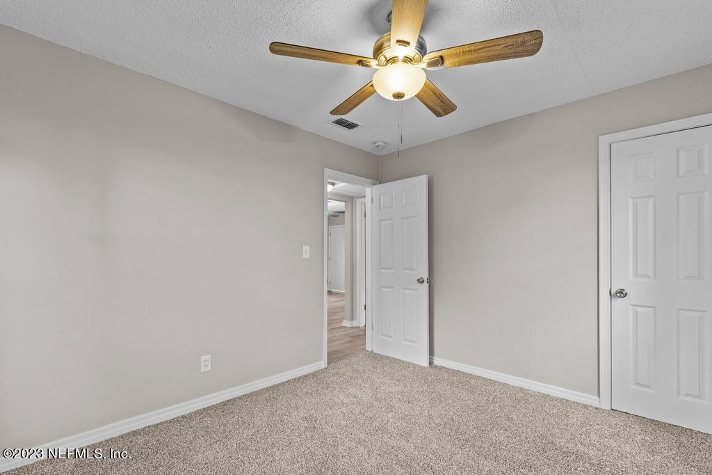 1023 Seba Street Jacksonville, FL 32205 - Photo 19 of 27 an empty room with chandelier fan