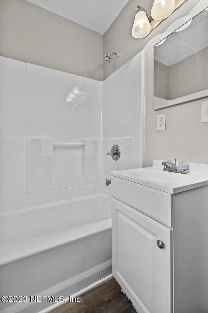 1023 Seba Street Jacksonville, FL 32205 - Photo 22 of 27 a bathroom with a bathtub sink vanity and a mirror