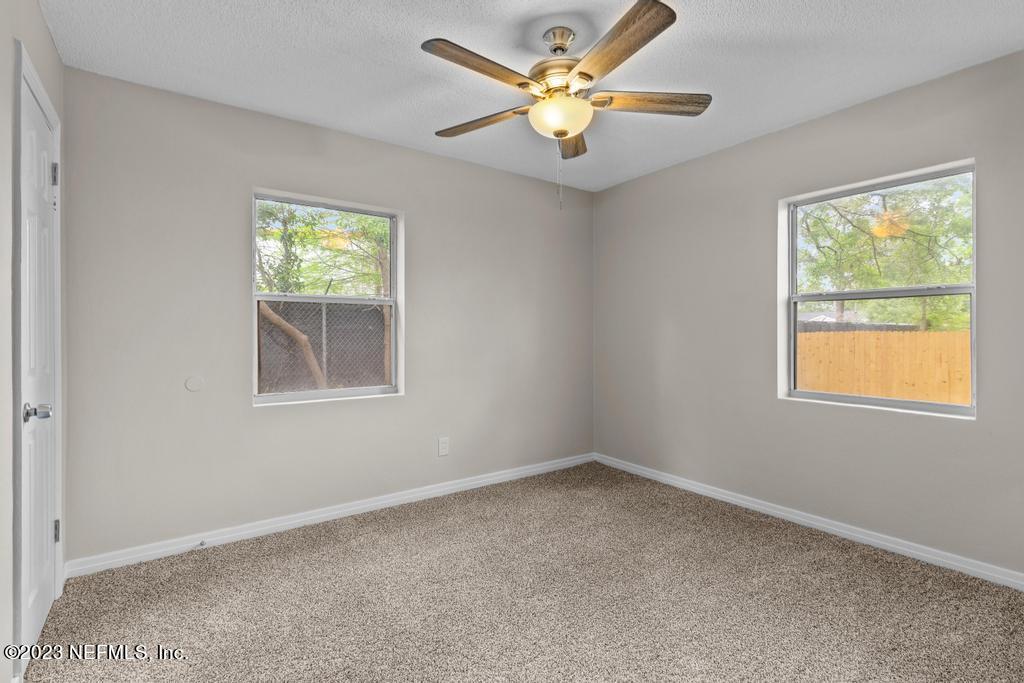 1023 Seba Street Jacksonville, FL 32205 - Photo 23 of 27 an empty room with windows and fan
