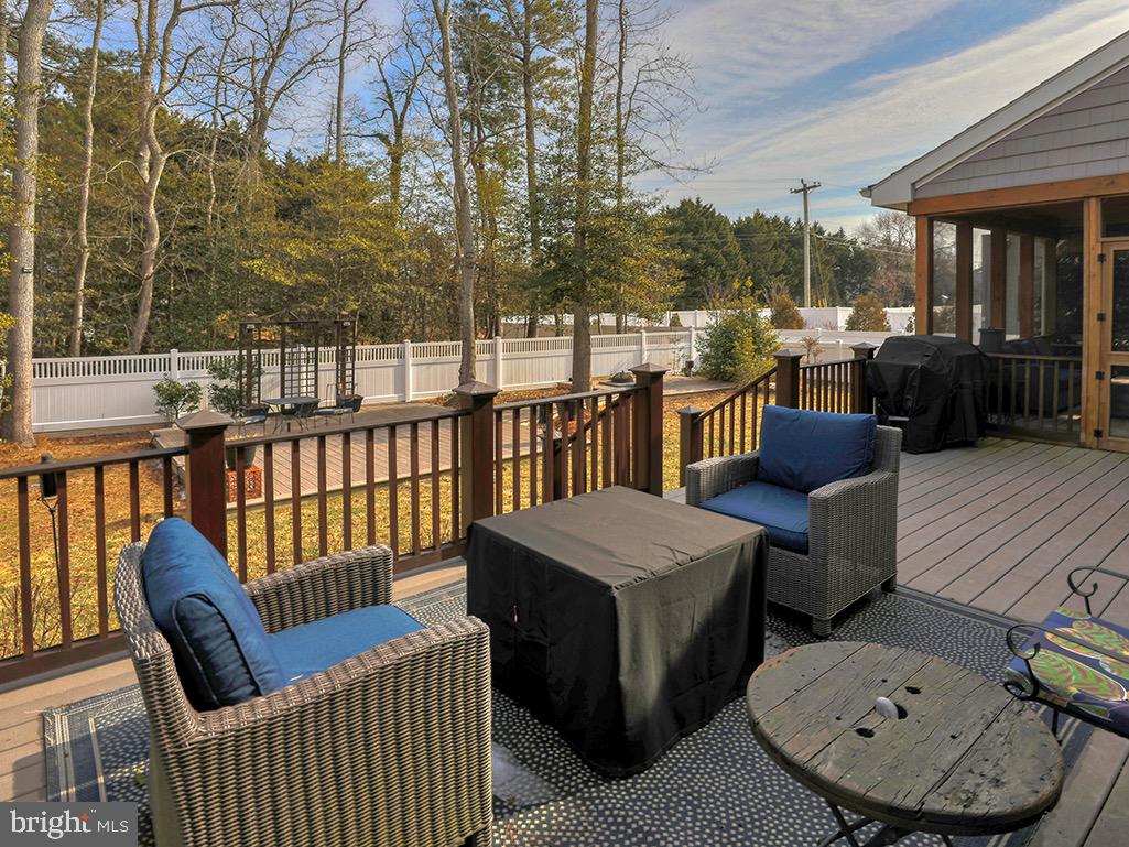 135 Cornwall Road Rehoboth Beach, DE 19971 - Photo 14 of 101 a view of a deck with couches table and chairs