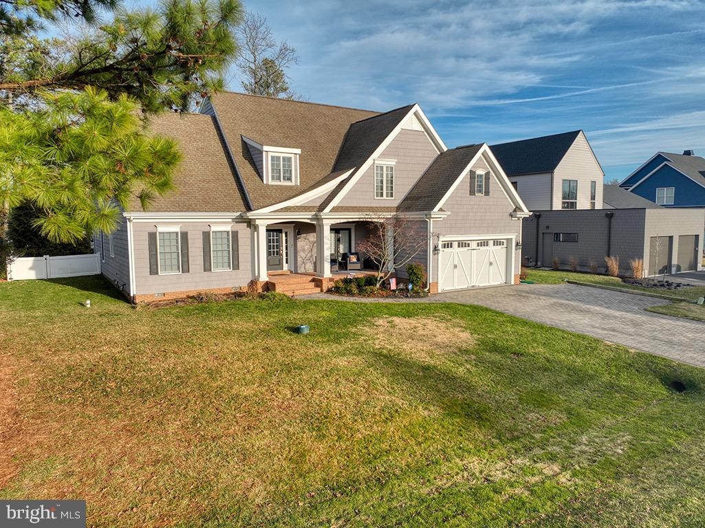 135 Cornwall Road Rehoboth Beach, DE 19971 - Photo 2 of 101 a front view of a house with a yard