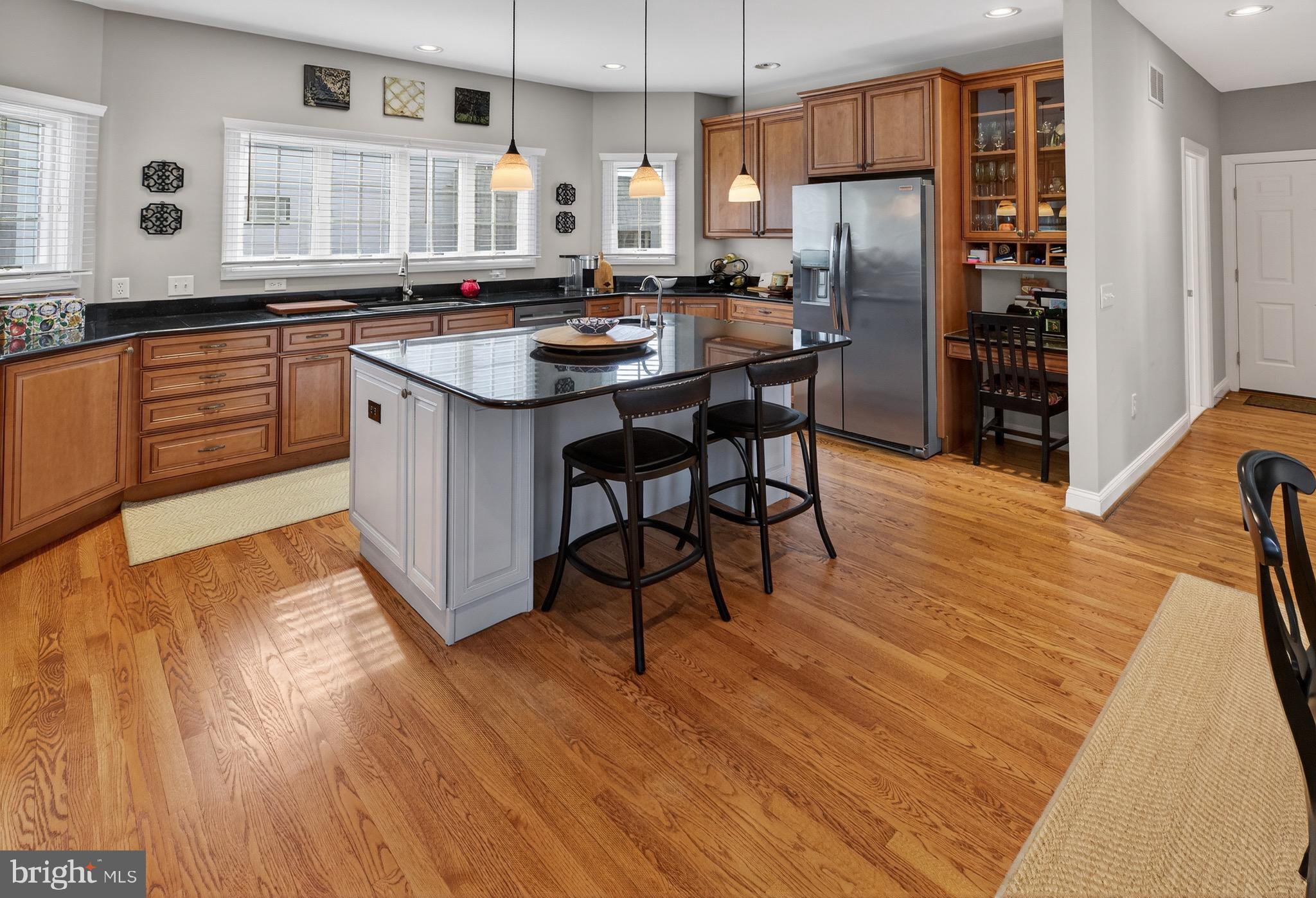 135 Cornwall Road Rehoboth Beach, DE 19971 - Photo 30 of 101 a kitchen with stainless steel appliances granite countertop a refrigerator a sink dishwasher a stove and white countertops with wooden floor