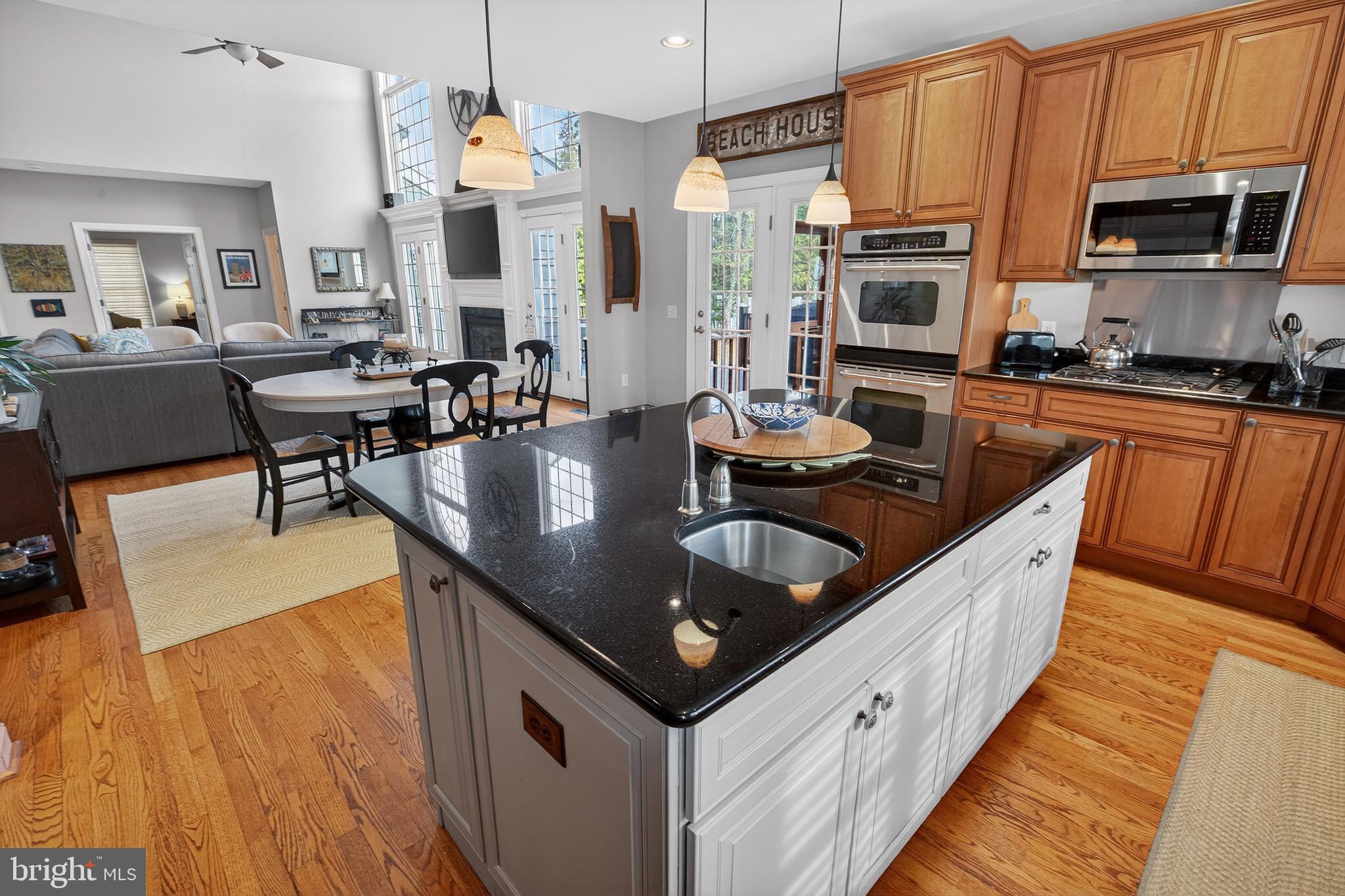135 Cornwall Road Rehoboth Beach, DE 19971 - Photo 32 of 101 a kitchen with stainless steel appliances granite countertop a sink a stove and a wooden floors