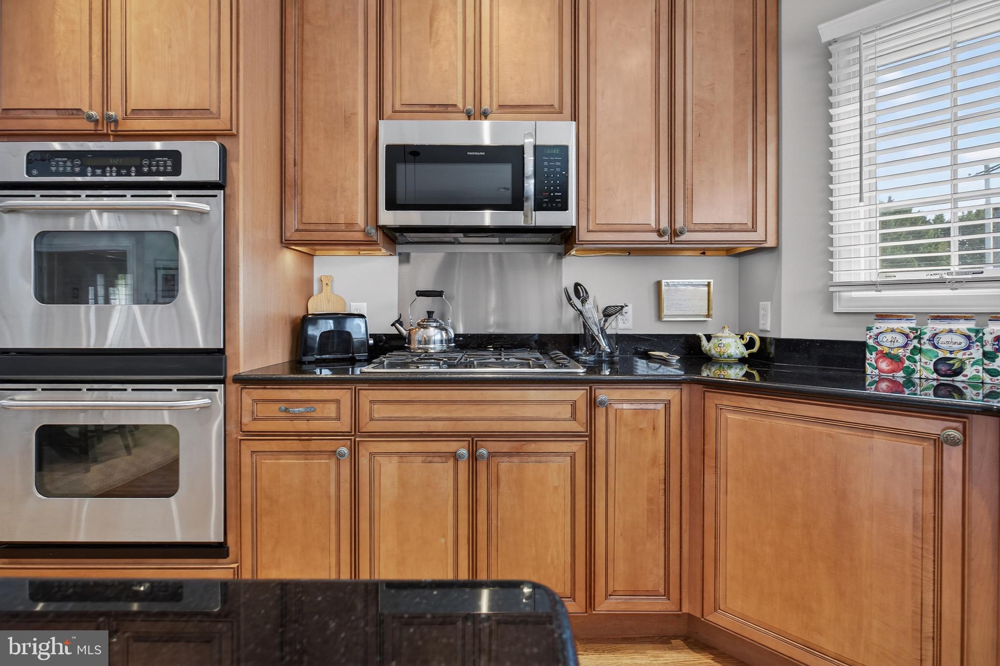 135 Cornwall Road Rehoboth Beach, DE 19971 - Photo 33 of 101 a kitchen with stainless steel appliances granite countertop a stove a sink and a microwave