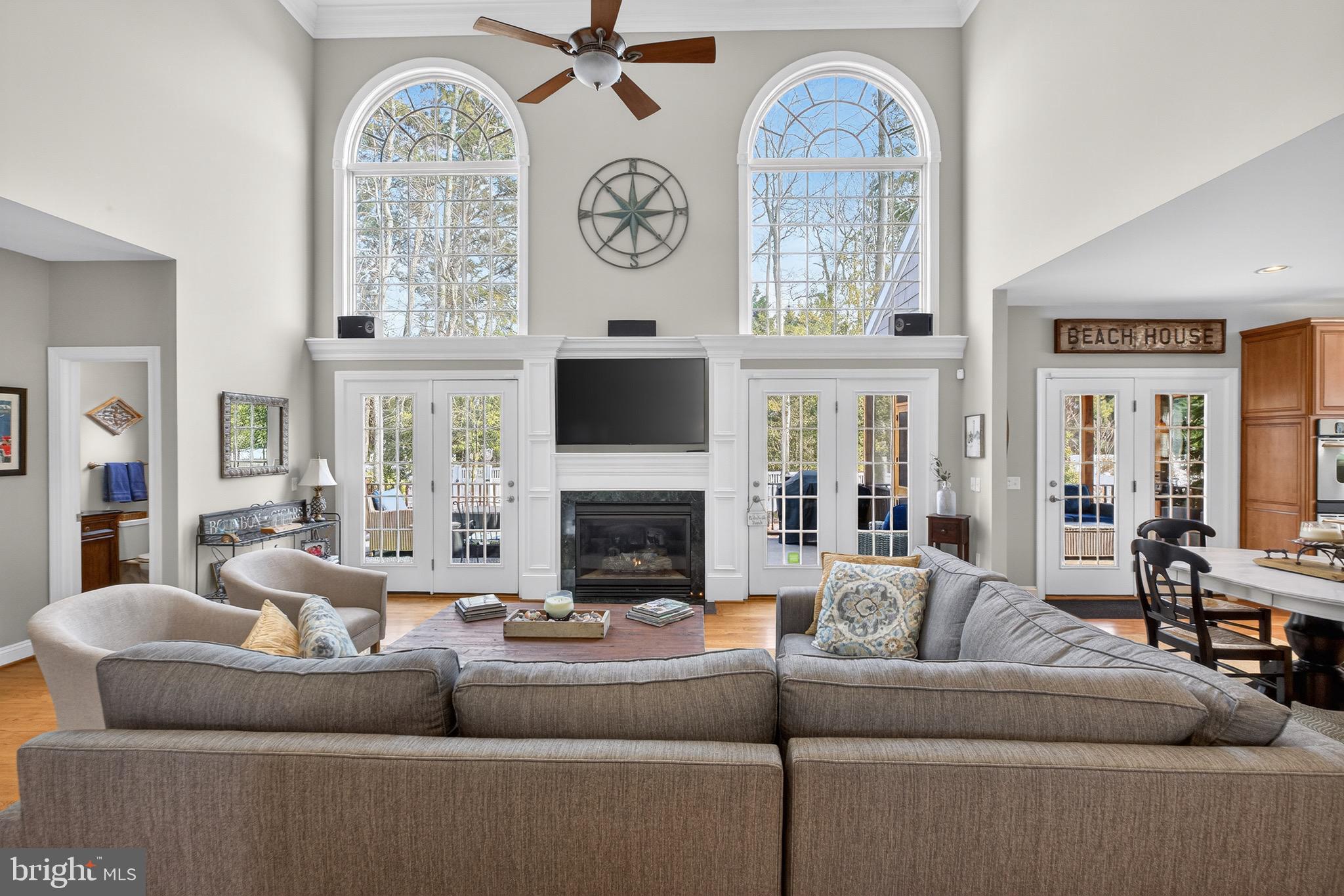 135 Cornwall Road Rehoboth Beach, DE 19971 - Photo 4 of 101 a living room with furniture a fireplace and a large window