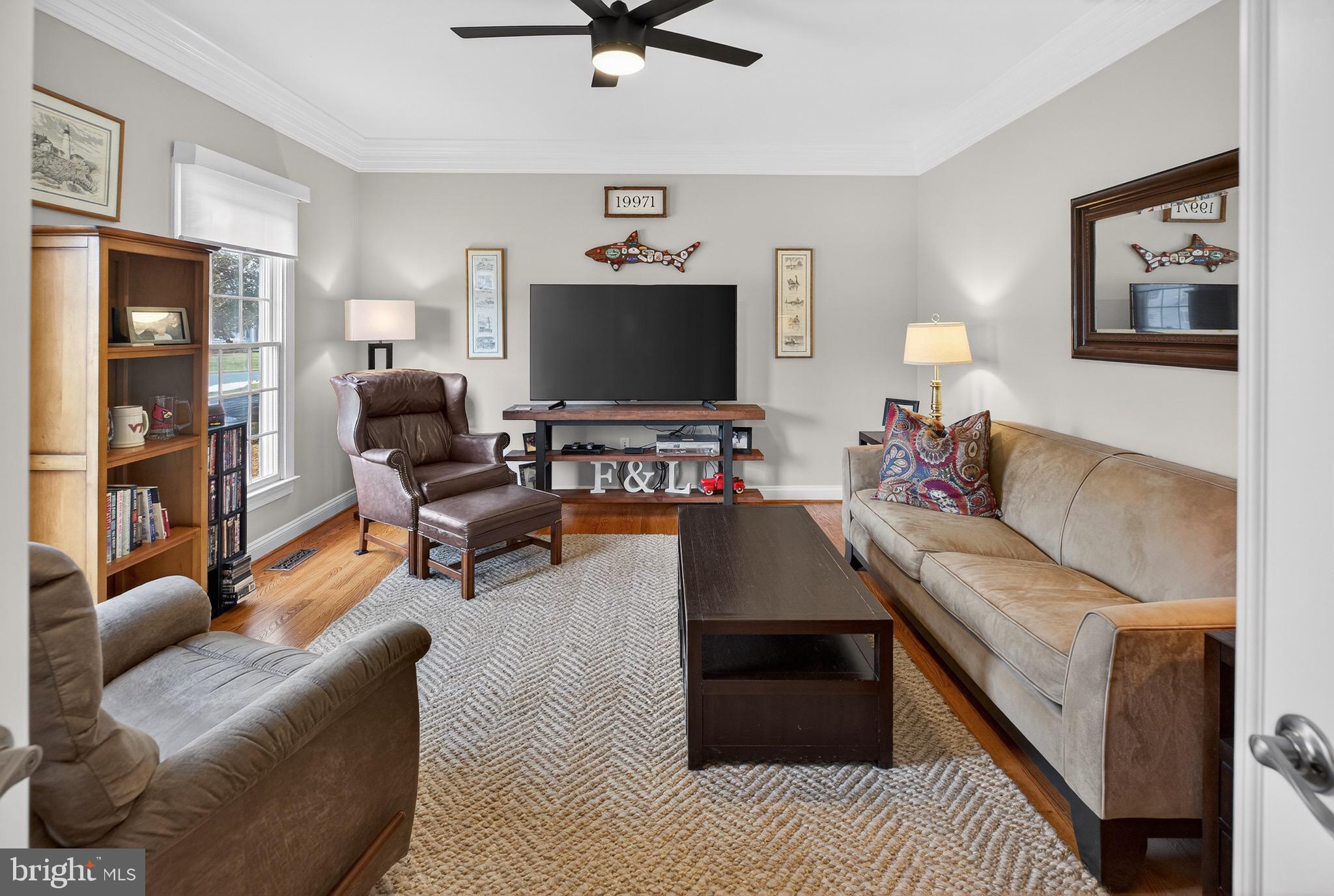 135 Cornwall Road Rehoboth Beach, DE 19971 - Photo 45 of 101 a living room with furniture and a flat screen tv