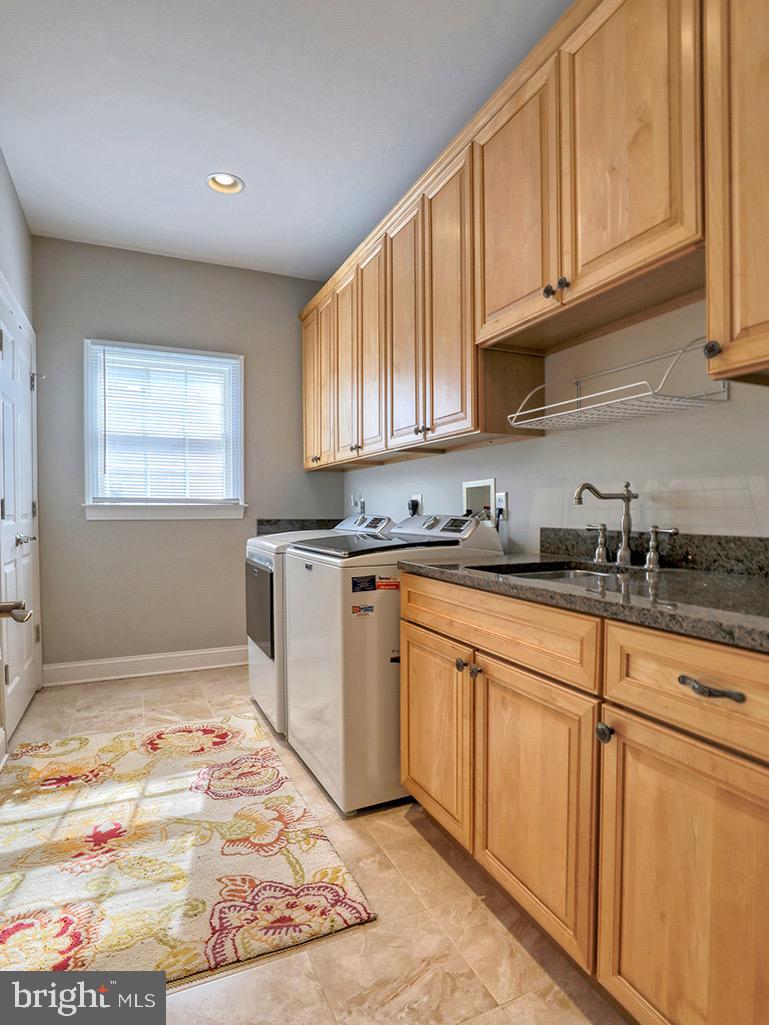 135 Cornwall Road Rehoboth Beach, DE 19971 - Photo 47 of 101 a kitchen with granite countertop a sink cabinets stainless steel appliances and a window