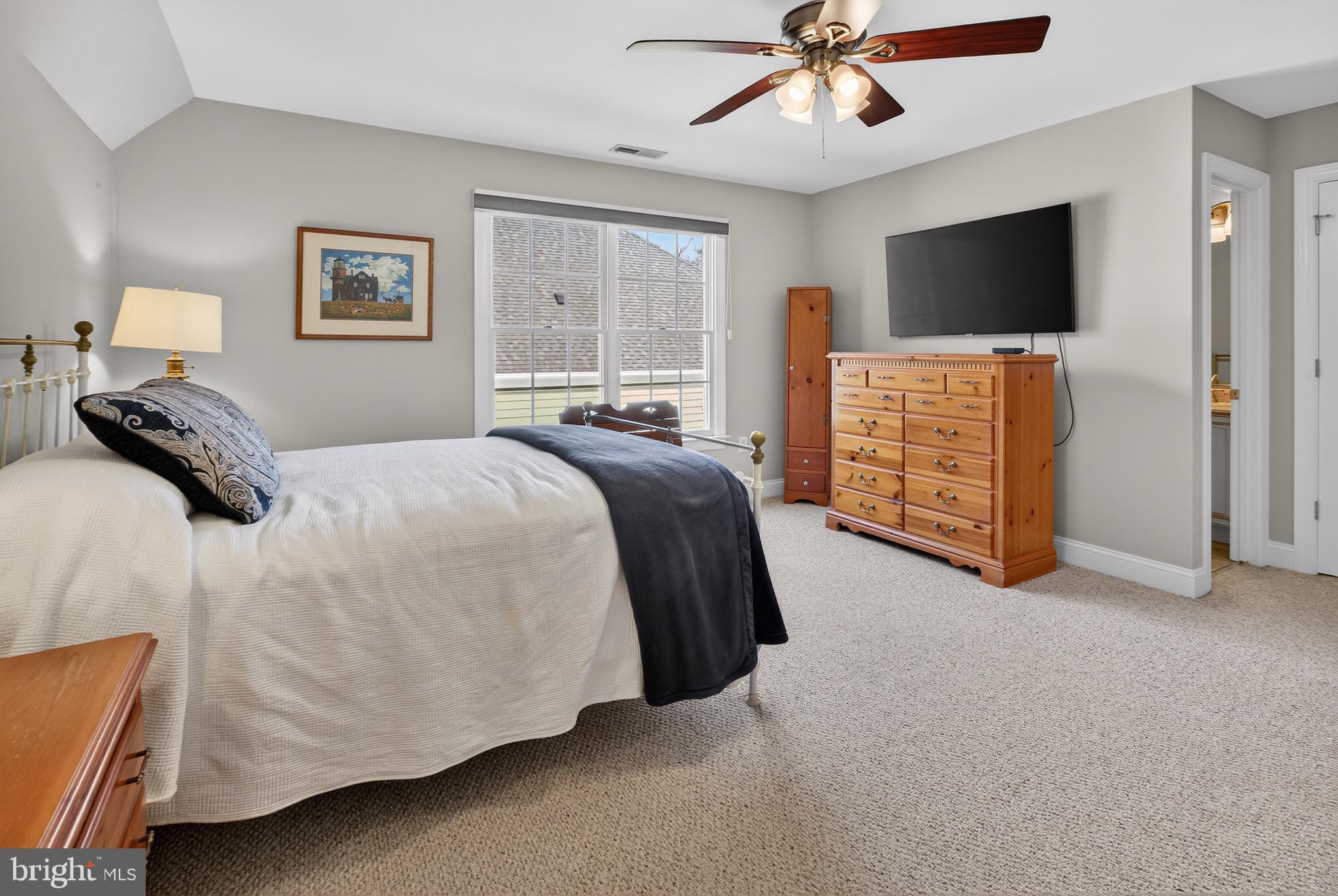135 Cornwall Road Rehoboth Beach, DE 19971 - Photo 52 of 101 a spacious bedroom with a bed and a flat screen television