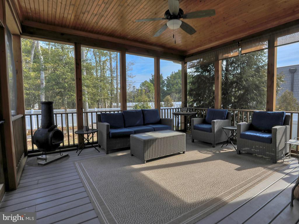 135 Cornwall Road Rehoboth Beach, DE 19971 - Photo 10 of 101 a living room with furniture a ceiling fan and a large window