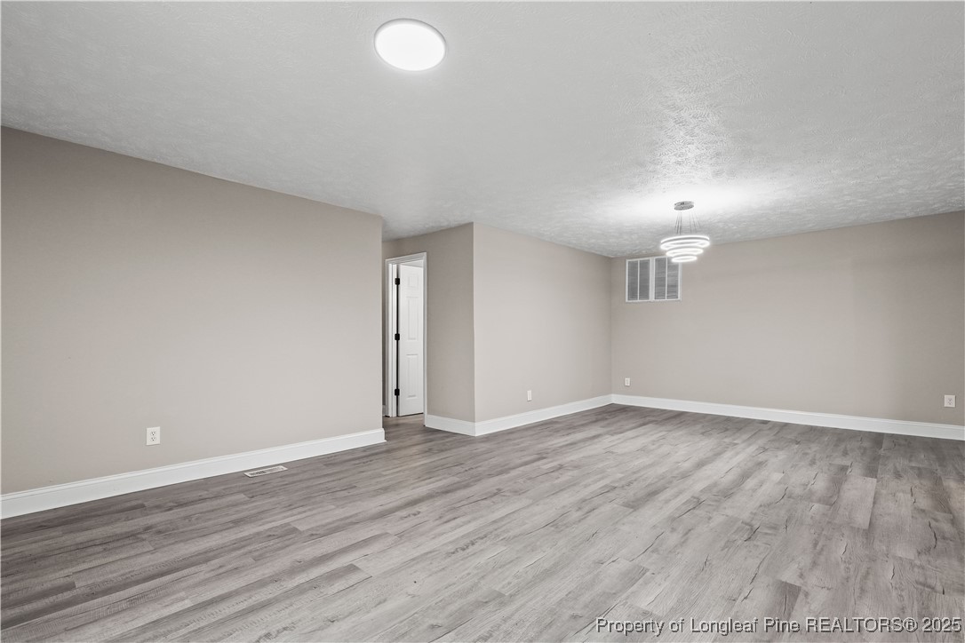 2302 Odom Road Hope Mills, NC 28348 - Photo 4 of 33 a view of an empty room with wooden floor