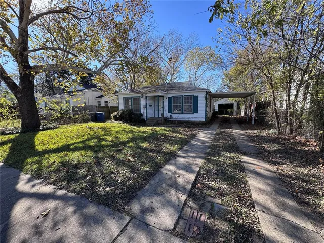 a house that has a tree in front of the house