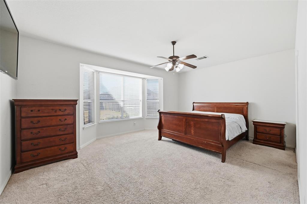 2319 Goshawk Street Grand Prairie, TX 75052 - Photo 16 of 40 a bedroom with a bed and a dresser