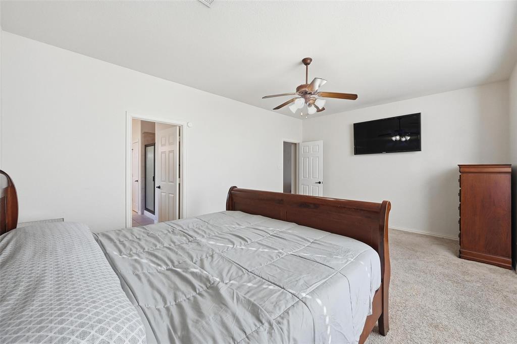 2319 Goshawk Street Grand Prairie, TX 75052 - Photo 17 of 40 a bedroom with a bed and a flat screen tv