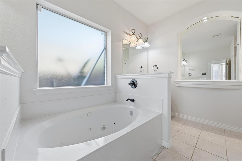 2319 Goshawk Street Grand Prairie, TX 75052 - Photo 19 of 40 a white bath tub sitting next to a white sink