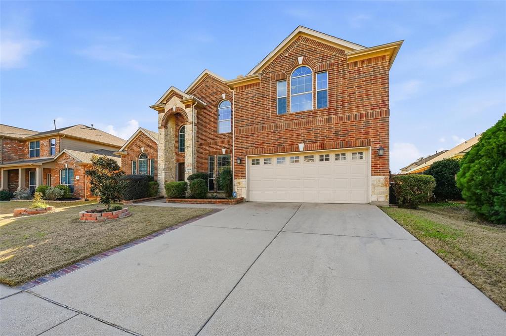 2319 Goshawk Street Grand Prairie, TX 75052 - Photo 3 of 40 a front view of a house with yard and parking