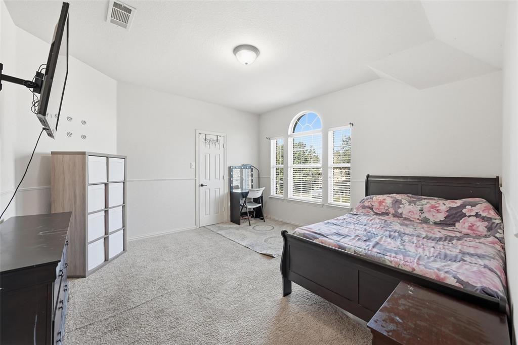 2319 Goshawk Street Grand Prairie, TX 75052 - Photo 32 of 40 a bedroom with a bed and a large window