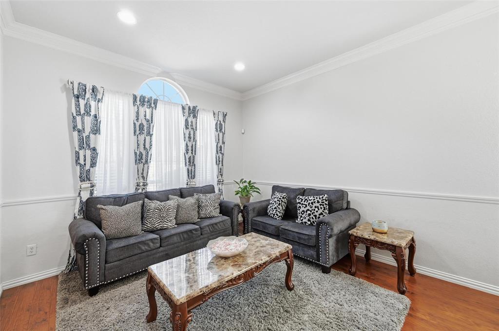2319 Goshawk Street Grand Prairie, TX 75052 - Photo 7 of 40 a living room with furniture and a potted plant