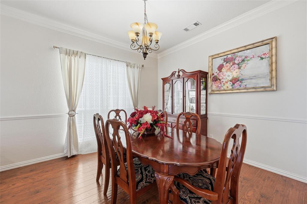 2319 Goshawk Street Grand Prairie, TX 75052 - Photo 8 of 40 a view of a dining room with furniture window and wooden floor