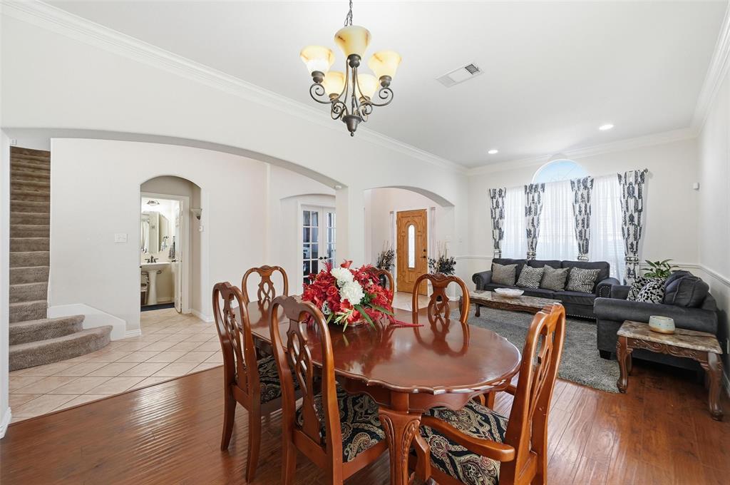 2319 Goshawk Street Grand Prairie, TX 75052 - Photo 9 of 40 a view of a dining room with furniture and wooden floor