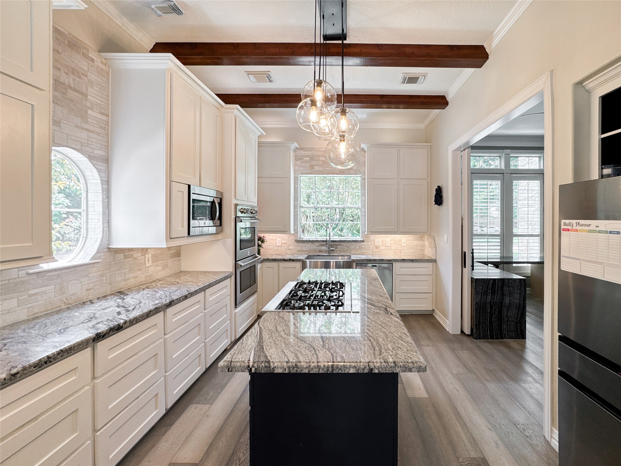 1810 Woerner Road Houston, TX 77090 - Photo 11 of 39 Modern kitchen island with sleek cooktop, perfect for culinary enthusiasts.