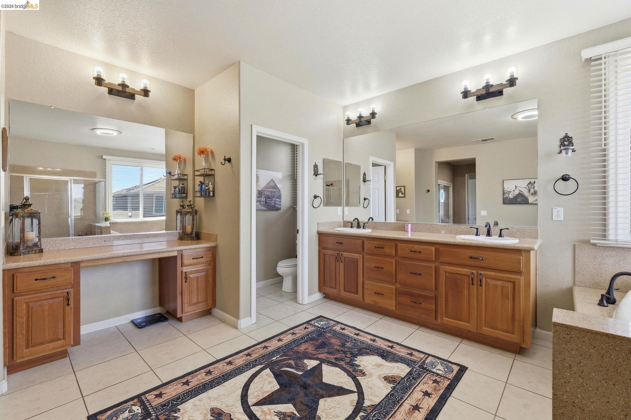3438 Keystone Loop Discovery Bay, CA 94505 - Photo 27 of 57 a large bathroom with a granite countertop double vanity sink a mirror and a bathtub