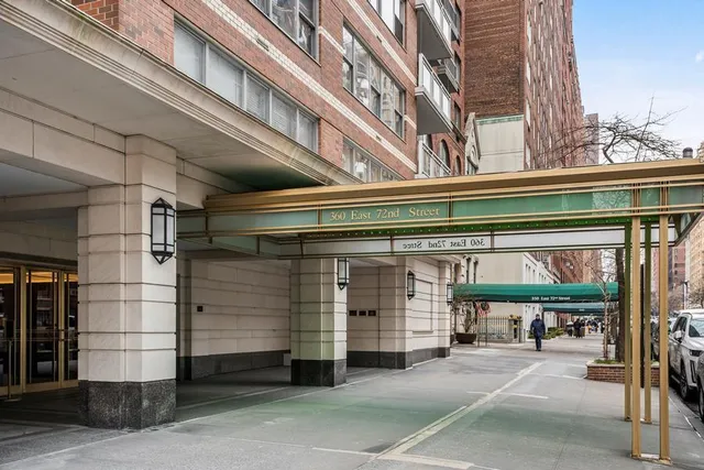 a kitchen with stainless steel appliances kitchen island granite countertop a stove and white cabinets