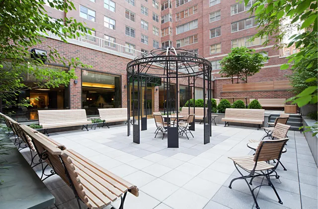 a view of a patio with a table and chairs and potted plants