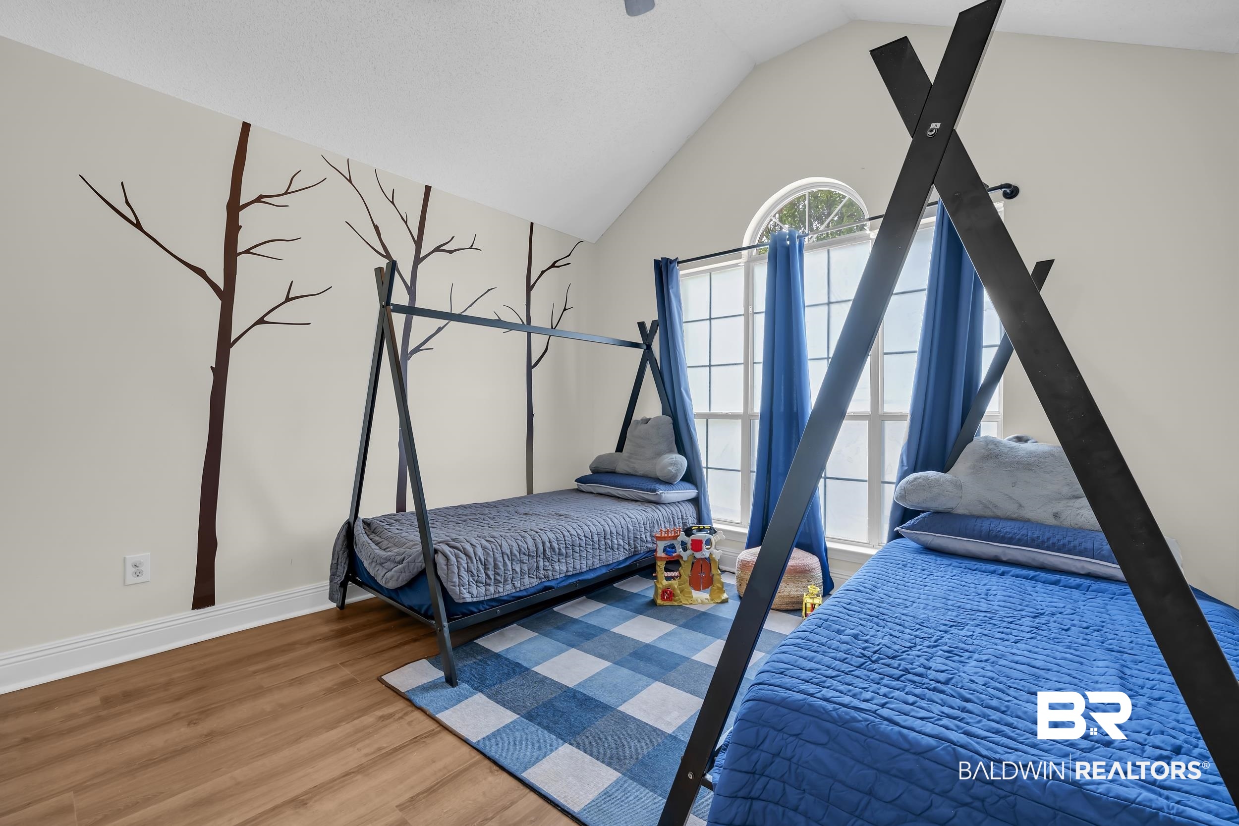 509 Loblolly Court Foley, AL 36535 - Photo 18 of 26 Vaulted ceilings with an arched window and wood-finish flooring