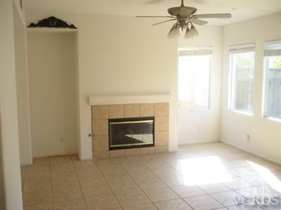1621 Sonata Drive Oxnard, CA 93030 - Photo 2 of 4 a view of an empty room with a fireplace and a window