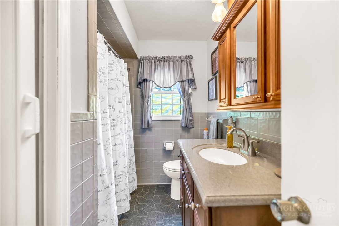 346 Piney Creek Road Lansing, NC 28643 - Photo 19 of 24 a bathroom with a sink toilet and shower
