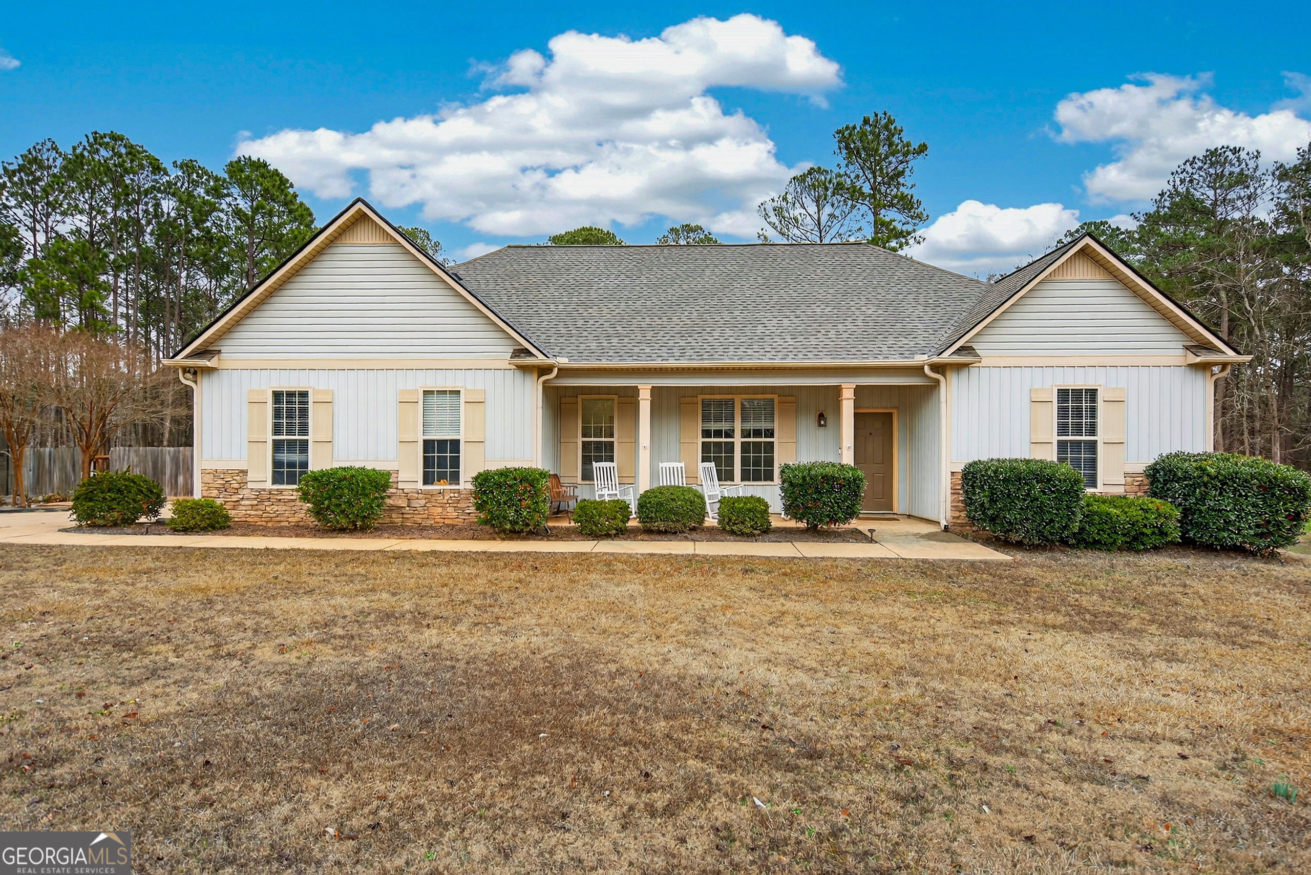 a front view of a house with a garden