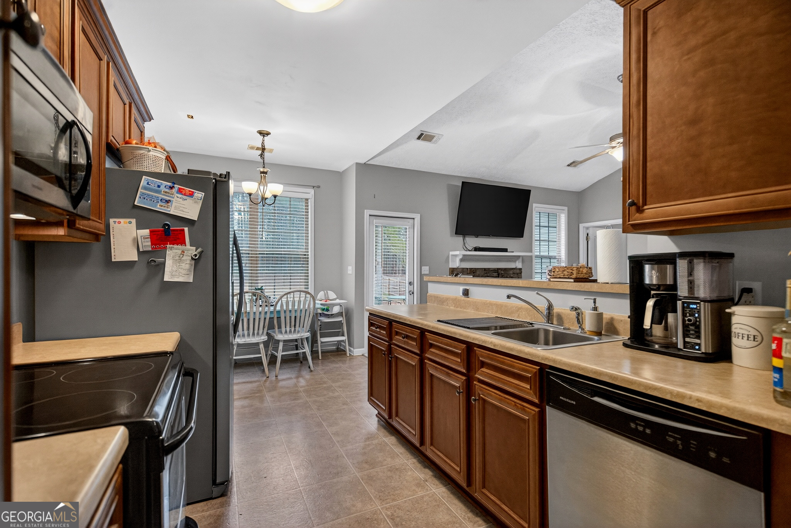 107 Amhurst Drive West Point, GA 31833 - Photo 12 of 29 a kitchen with stainless steel appliances granite countertop a sink stove and refrigerator