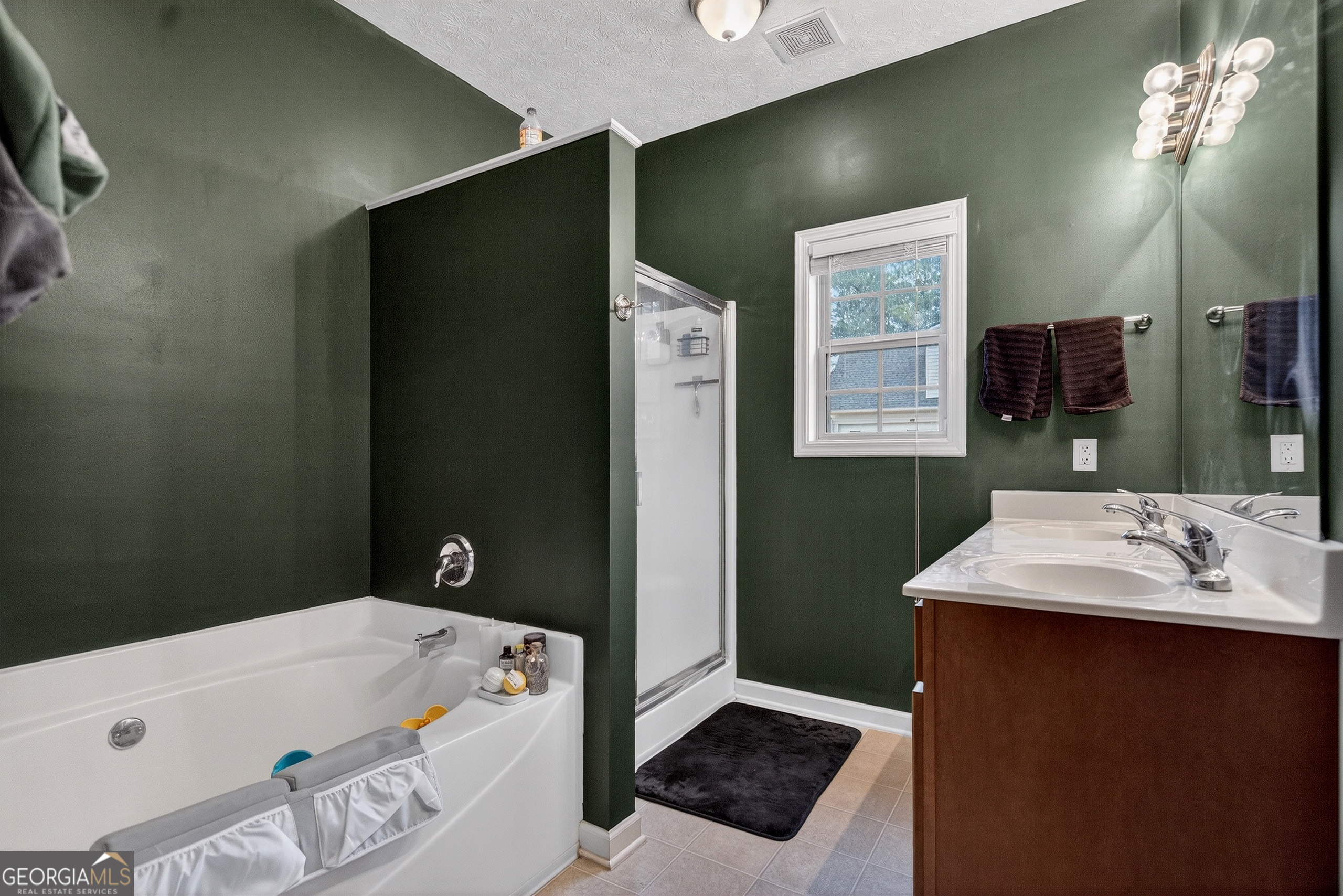 107 Amhurst Drive West Point, GA 31833 - Photo 18 of 29 a bathroom with a sink a mirror and a shower