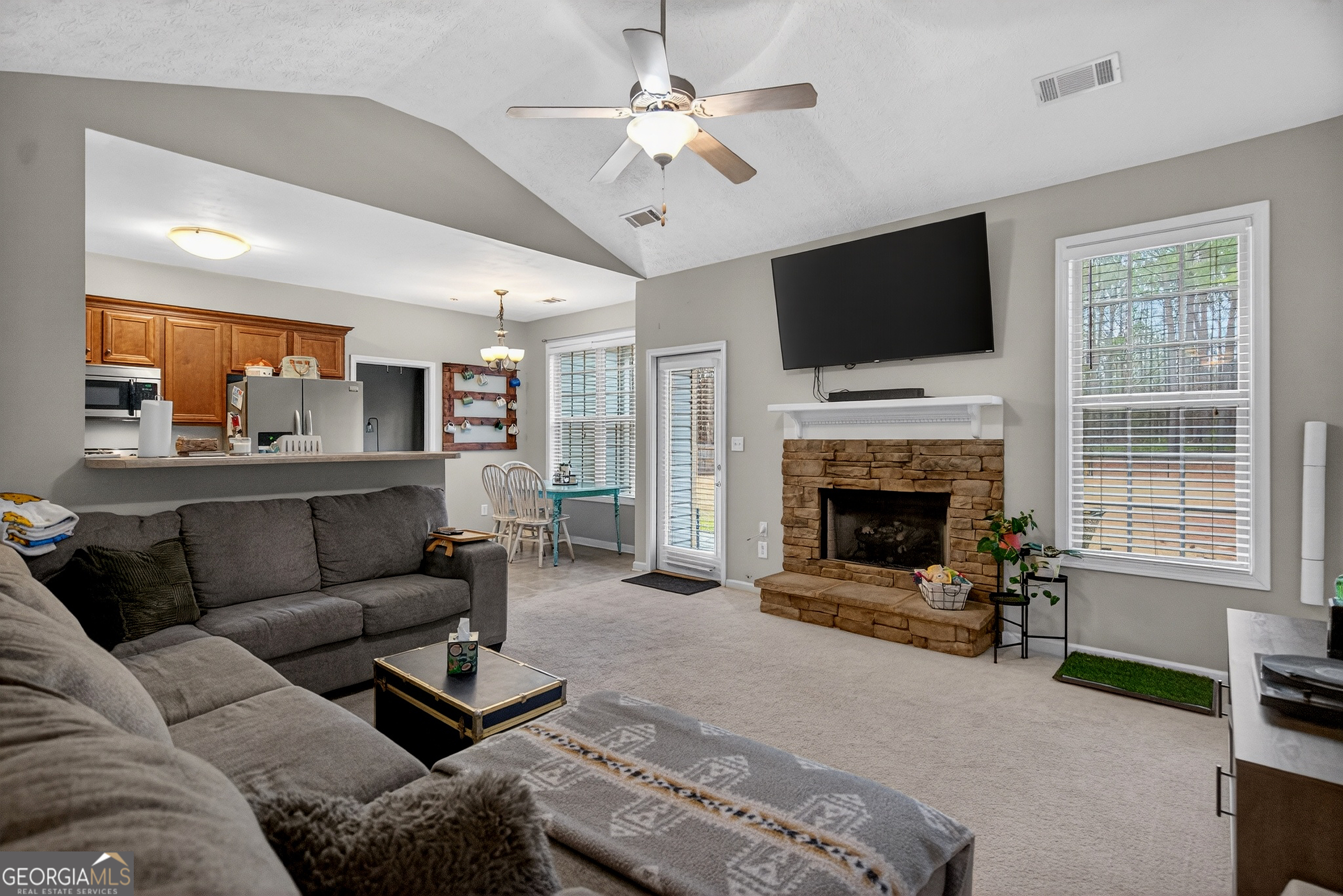 107 Amhurst Drive West Point, GA 31833 - Photo 9 of 29 a living room with furniture a flat screen tv and a fireplace