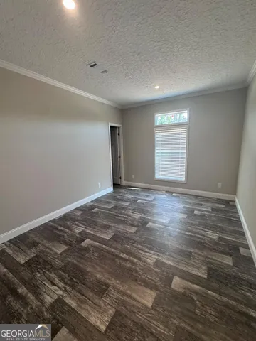 a large kitchen with kitchen island a stove a sink dishwasher and a dining table with wooden floor