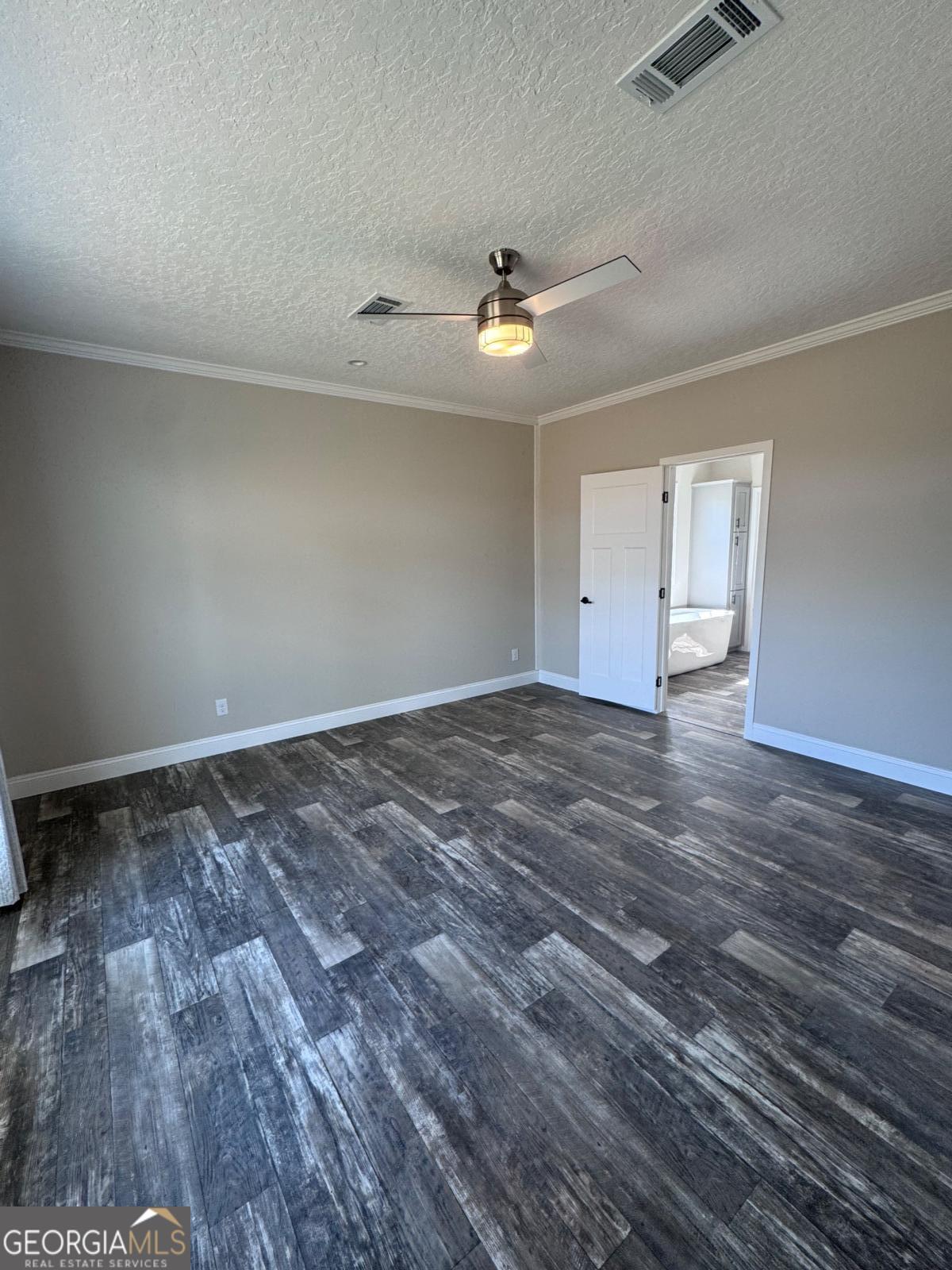 44 Long Leaf Road Hazlehurst, GA 31539 - Photo 14 of 21 an empty room with wooden floor ceiling fan and window