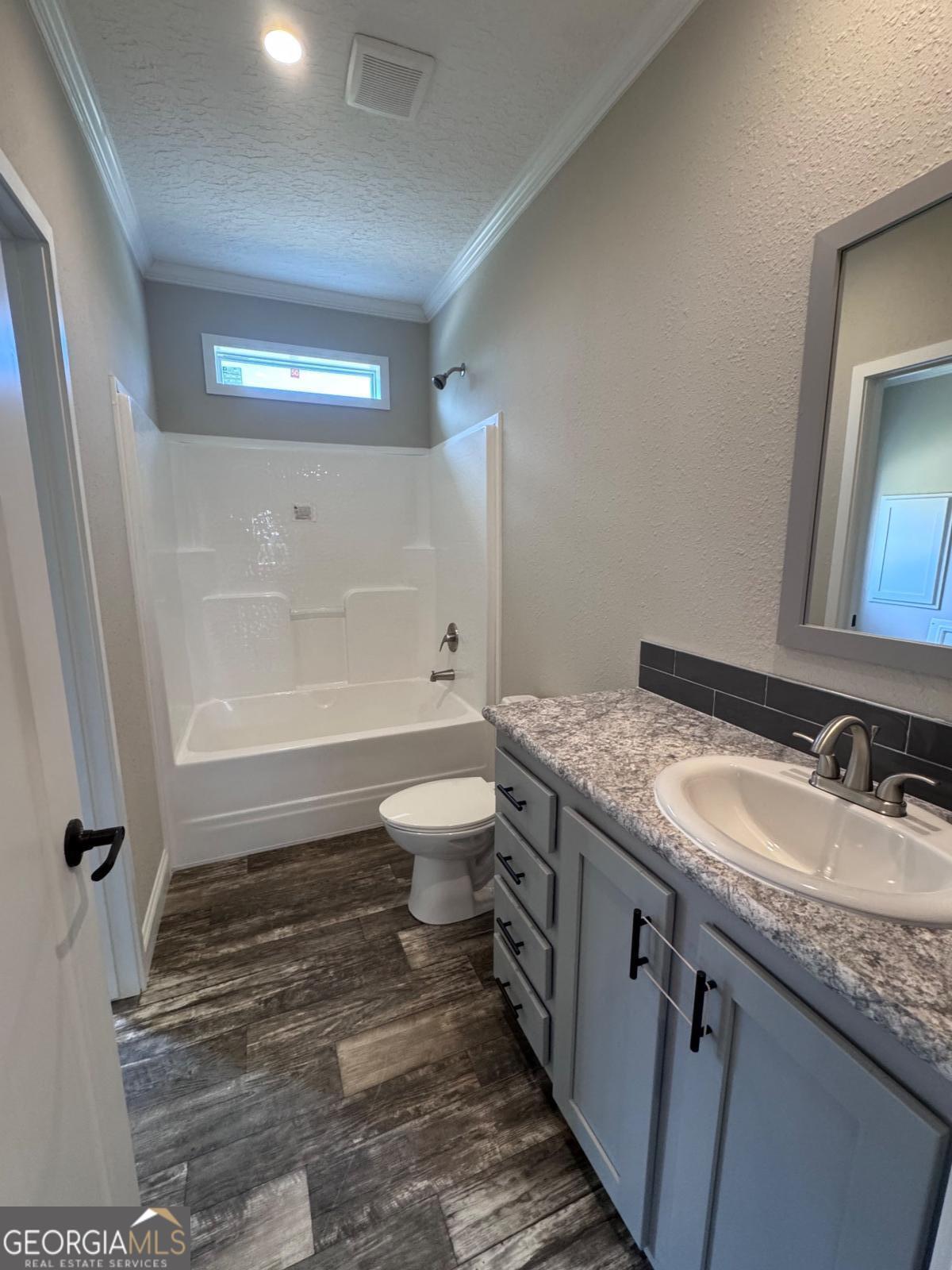 44 Long Leaf Road Hazlehurst, GA 31539 - Photo 19 of 21 a bathroom with a granite countertop sink toilet and shower