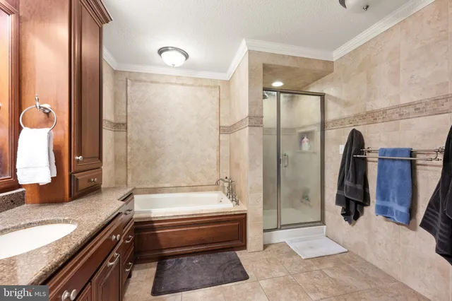 a bathroom with a tub a sink and shower