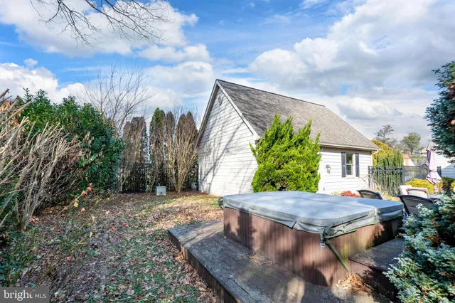 a view of a house with backyard sitting area and garden