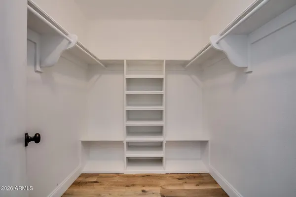 a view of walk in closet with empty racks