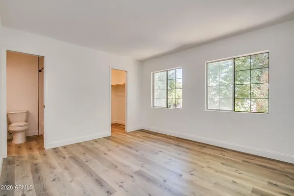 a view of a room with wooden floor and windows