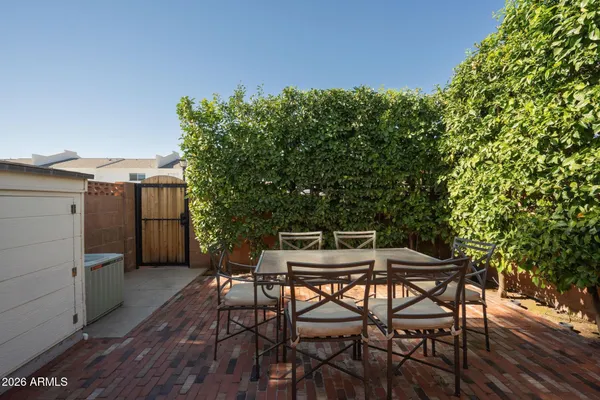 a backyard of a house with table and chairs