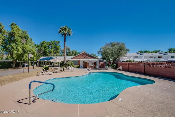 a swimming pool with outdoor seating and yard